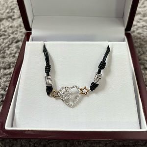 High end fashion bracelet with leather band. Never worn. Brand new.